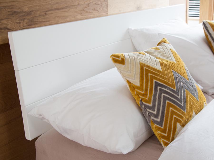 white wooden headboard floating bed